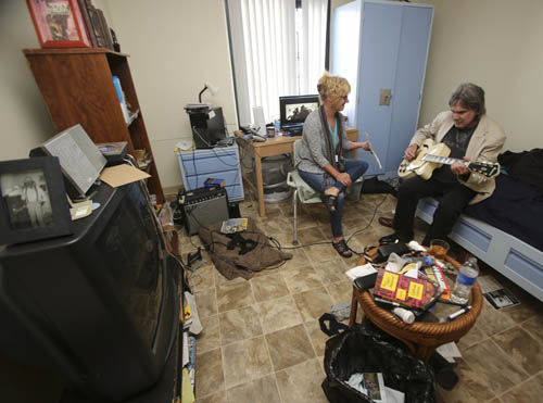 Dec. 4, 2015. San Diego,  CA. USA|John Brizzolara plays his guitar with case manager Molly Turner holding a poem that she wrote that John put music to. John lives in a permanent supportive housing unit at the Villa Harvey Mandelaptarments, a part of the Father Joe's Villages affordable housing. |Photos by Jamie Scott Lytle. Copyright.
